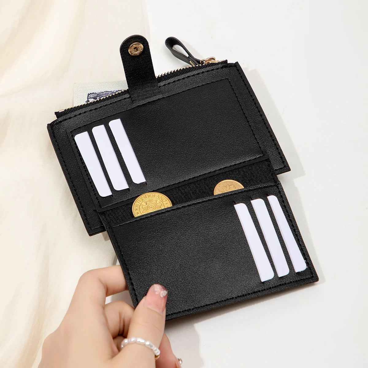 Yaffa Jana mini card wallet in beige, black, pink and blue