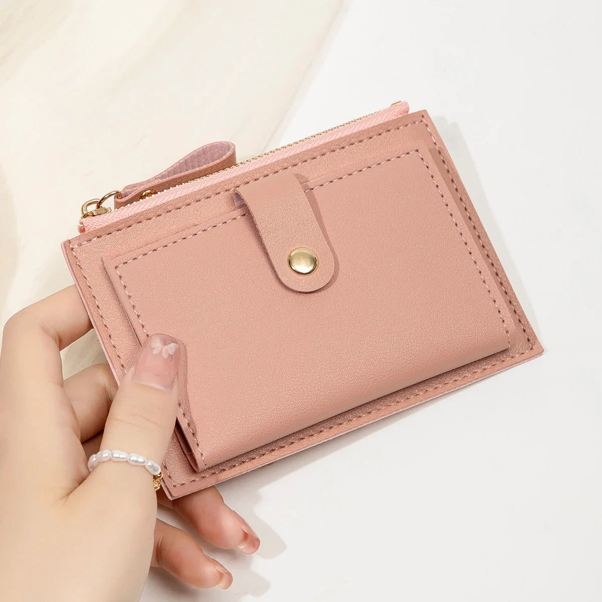 Yaffa Jana mini card wallet in beige, black, pink and blue