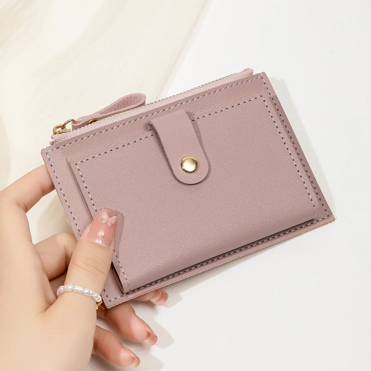 Yaffa Jana mini card wallet in beige, black, pink and blue